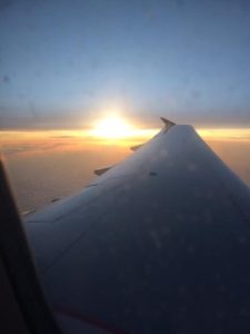 Airplane wing at sunrise from the plane window